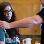 A Snohomish County Corrections officer takes Amy Brown from the courtroom follwing sentencing Tuesday by Superior Court Judge Michael Downes. (Dan Bates / The Herald)