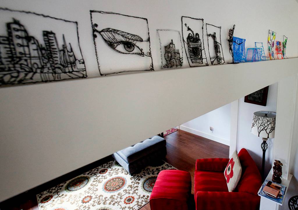 The wooden moldings used in the remodel of the Coghill houses provide a wide enough edge to support an art collection. (Dan Bates / The Herald)
