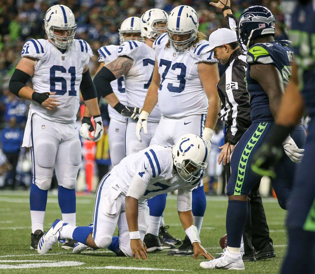 Colts quarterback Jacoby Brissett is slow to get up after a sack by the Seahawks Sunday night at CenturyLink Field in Seattle on October 1, 2017. Seahawks won 46-18. (Kevin Clark / The Herald)