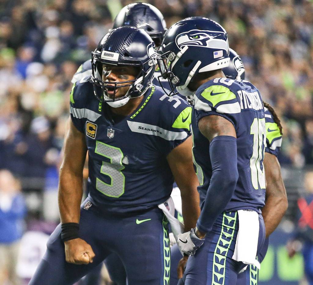 Seahawks quarterback Russell Wilson celebrates his rushing touchdown against the Colts Sunday night at CenturyLink Field in Seattle on October 1, 2017. Seahawks won 46-18. (Kevin Clark / The Herald)