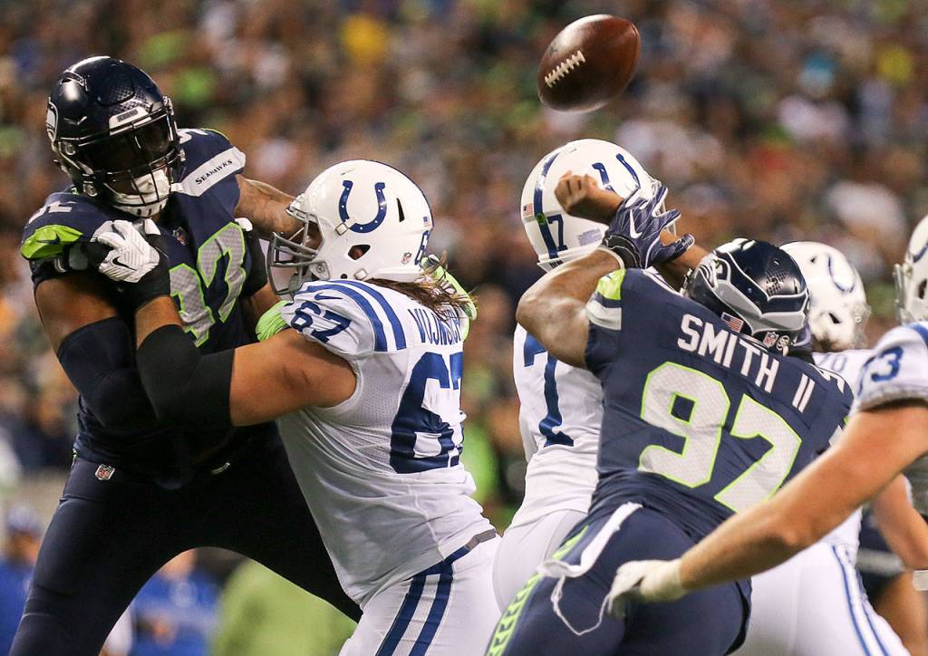 Seahawks defensive lineman Marcus Smith forces a fumble by Colts quarterback Jacoby Brissett resulting in the Seahawks linebacker Bobby Wagner, not pictured, touchdown Sunday night at CenturyLink Field in Seattle on October 1, 2017. Seahawks won 46-18. (Kevin Clark / The Herald)
