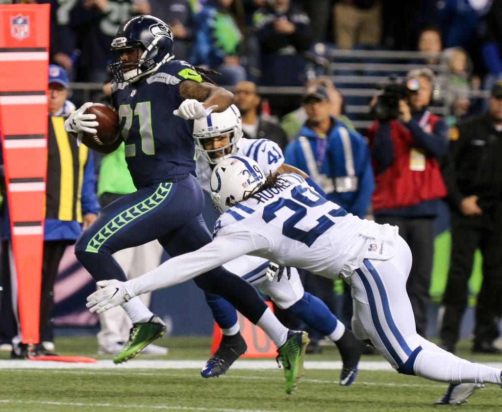 Seahawks running back J.D. McKissic breaks the tackle attempts by Colts safety Matthias Farley and Colts safety Malik Hooker for a touchdown Sunday night at CenturyLink Field in Seattle on October 1, 2017. Seahawks won 46-18. (Kevin Clark / The Herald)