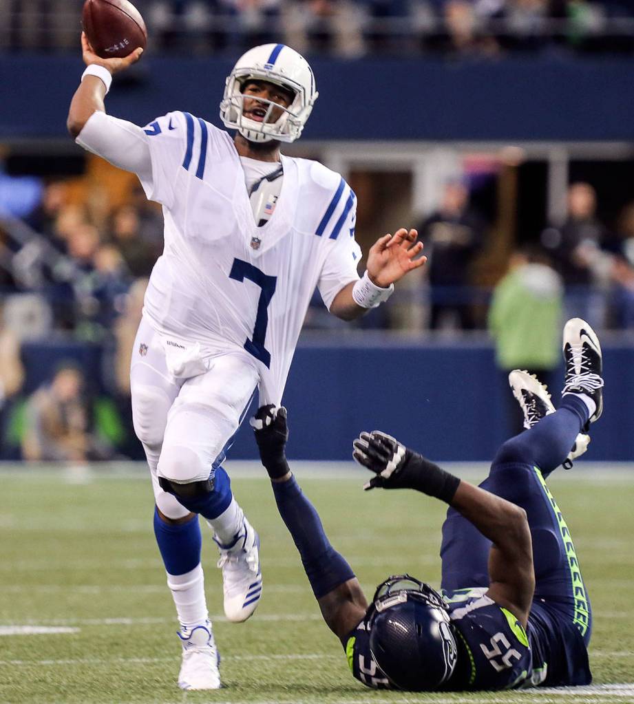Colts quarterback Jacoby Brissett gets a pass off with Seahawks defensive lineman Frank Clark holding on Sunday night at CenturyLink Field in Seattle on October 1, 2017. Seahawks won 46-18. (Kevin Clark / The Herald)