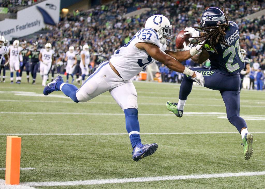 Seahawks running back J.D. McKissic makes a touchdown reception over Colts linebacker Jon Bostic Sunday night at CenturyLink Field in Seattle on October 1, 2017. Seahawks won 46-18. (Kevin Clark / The Herald)