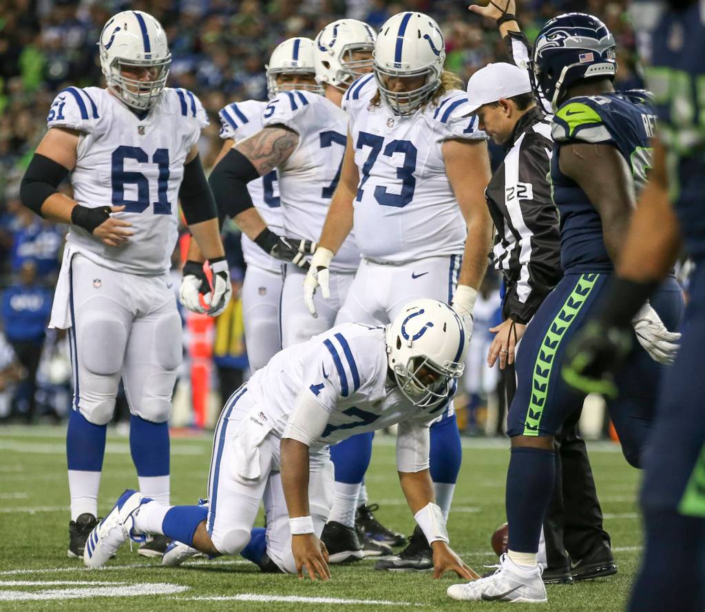 Colts quarterback Jacoby Brissett is slow to get up after a sack by the Seahawks Sunday night at CenturyLink Field in Seattle on October 1, 2017. Seahawks won 46-18. (Kevin Clark / The Herald)