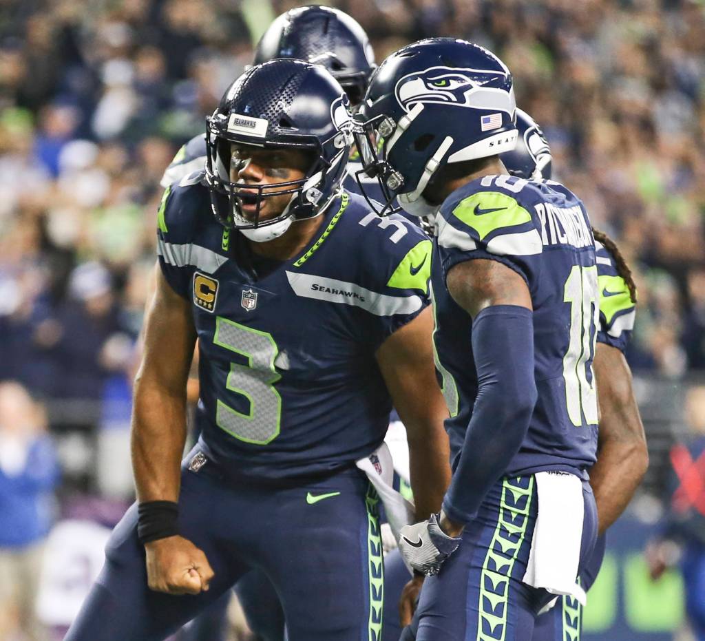 Seahawks quarterback Russell Wilson celebrates his rushing touchdown against the Colts Sunday night at CenturyLink Field in Seattle on October 1, 2017. Seahawks won 46-18. (Kevin Clark / The Herald)