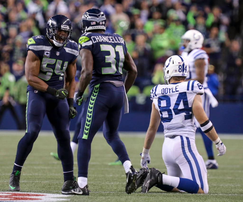 Seahawks linebacker Bobby Wagner, left, and Seahawks safety Kam Chancellor celebrates a pass by Chancellor on Colts tight end Jack Doyle Sunday night at CenturyLink Field in Seattle on October 1, 2017. Seahawks won 46-18. (Kevin Clark / The Herald)