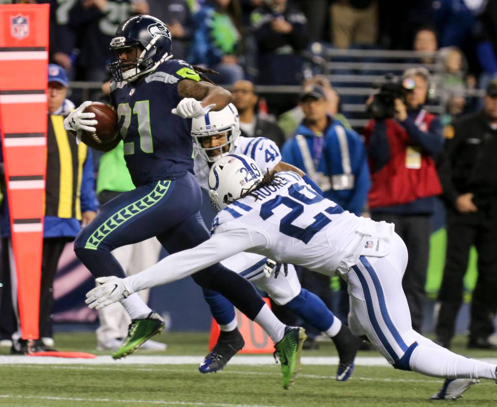 Seahawks running back J.D. McKissic breaks the tackle attempts by Colts safety Matthias Farley and Colts safety Malik Hooker for a touchdown Sunday night at CenturyLink Field in Seattle on October 1, 2017. Seahawks won 46-18. (Kevin Clark / The Herald)