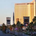 Police block a road on the Las Vegas Strip near the Mandalay Bay hotel and casino shortly after sunrise Monday in Las Vegas. (AP Photo/Ronda Churchill)