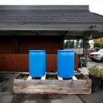 Rain barrels await installation at Experience Momentum in Lynnwood. (Ian Terry / The Herald)