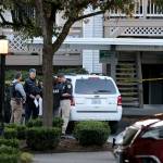 Members of the Everett Police Department confer at the scene where a boy was found shot. (Kevin Clark / The Herald)