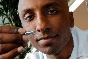 Dr. Maheer Gandhavadi looks at a tiny pacemaker, a demonstration version of the one he recently implanted in an 80-year-old patient at Providence Regional Medical Center Everett. It is only 2.6 centimeters in length, making it the worlds tiniest, at only one-tenth the size of traditional pacemakers. Gandhavadi is medical director of electrophysiology at Providence. (Dan Bates / The Herald)