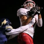 Marysville Pilchucks Justin Trueax makes a reception over Arlingtons Tucker Bovard during a game Oct. 6, 2017, at Arlington High School. (Kevin Clark / The Herald)