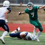 Edmonds-Woodway quarterback Reilly Chappell scrambles Friday during the Warriors game against visiting Meadowdale. (Ian Terry / The Herald)