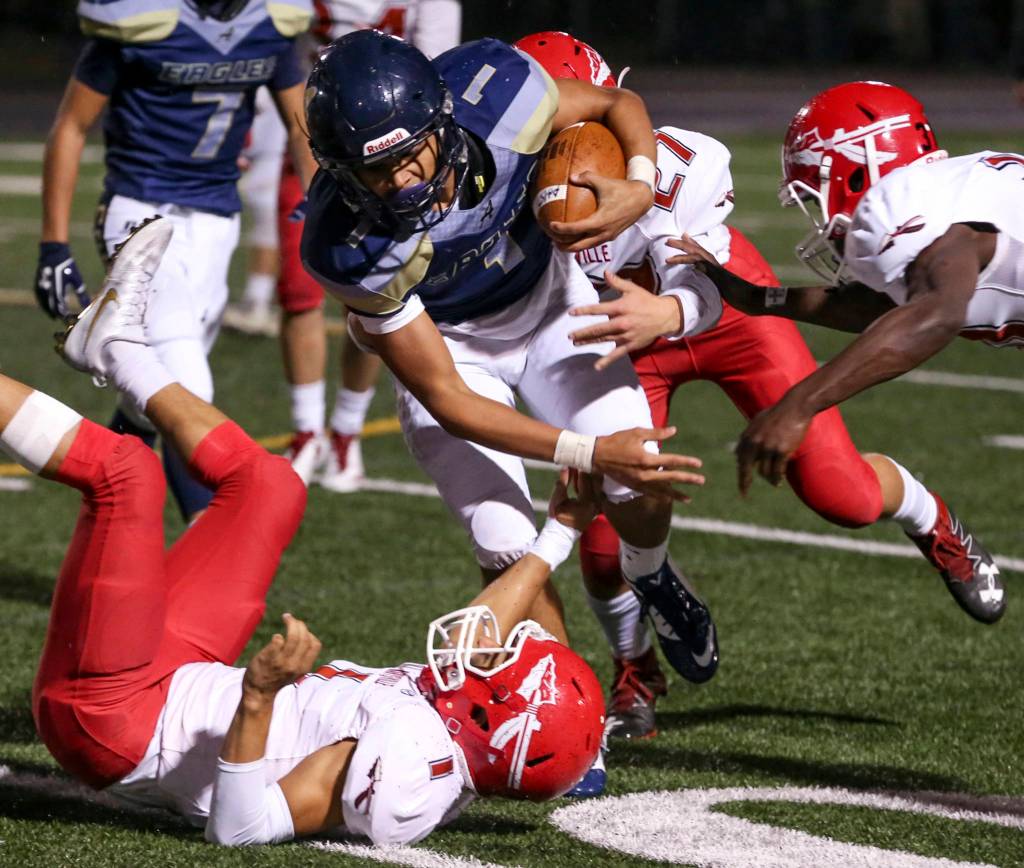 Arlingtons Tallen Williams rushes against the Marysville Pilchuck defense for extra yards at Arlington High School on Oct. 6. (Kevin Clark / The Herald)