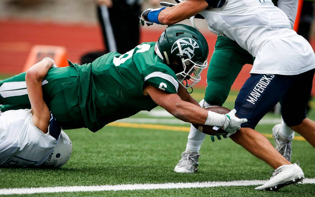 Edmonds-Woodways Cappasio Cherry dives into the end zone for a touchdown during a game against Meadowdale at Edmonds Stadium on Oct. 6. (Ian Terry / The Herald)