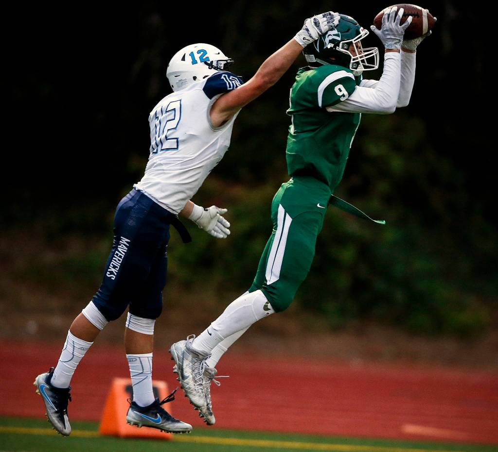 Edmonds-Woodways Noah Becker (9) intercepts a pass intended for Meadowdales Drew Harvey (12) during a game at Edmonds Stadium on Oct. 6. (Ian Terry / The Herald)
