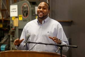 Dremond Stidwell, 44, delivers a speech during the EvCC Aviation Maintenance Technology Schools 50-year anniversay celebration Wednesday at Paine Field. Stidwell, who moved here from Atlanta for this opportunity, is a full-time student in the program and is already working in the industry. (Dan Bates / The Herald)