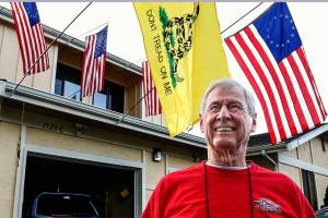 Korean War veteran Gerald Rogers, 85, of Everett, flies American flags outside his condominium in south Everett. Rogers recently took an Honor Flight trip to Washington, D.C. (Dan Bates / The Herald)