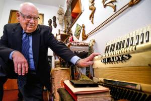 At the Gospel Light Church in Everett, founding member and longtime pastor, Newton Waldrop offers a peek inside a small room filled with memories covering several generations of his family who served here. His mother, Gladys played the accordion at right as well as the banjo. (Dan Bates / The Herald)