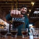 Barista Ryan Bisson pours one of the brews from Bean Box and reviews each while at Narrative Coffee on Oct. 3 in Everett. (Andy Bronson / The Herald)
