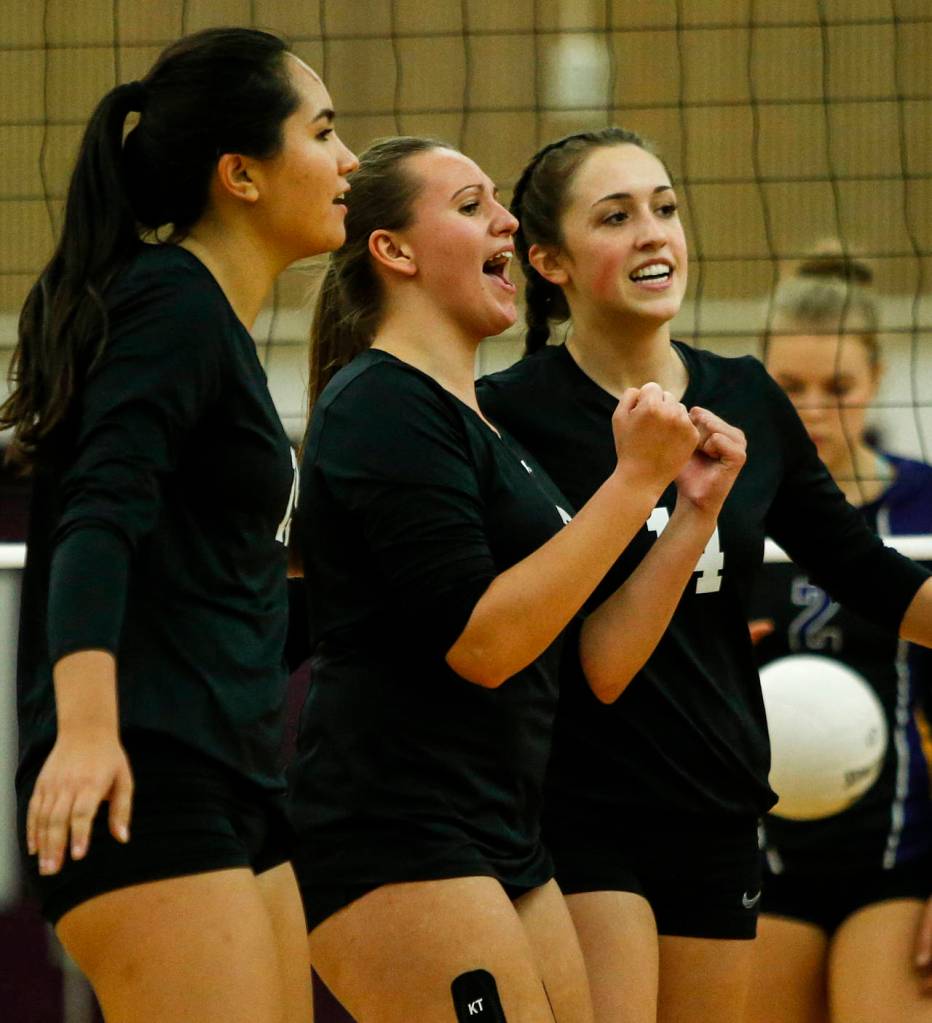 Kamiaks Hannah Knutt (center) celebrates a point with teammates during a game against Lake Stevens on Oct. 10, 2017, at Lake Stevens High School. (Ian Terry / The Herald)