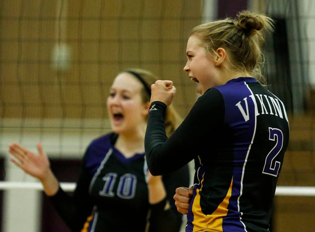 Lake Stevens Lillian Eason (2) and Anna Saack (10) celebrate a point during a game against Kamiak on Oct. 10, 2017, at Lake Stevens High School. (Ian Terry / The Herald)