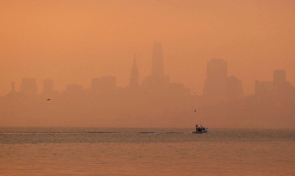 The San Francisco skyline is obscured by smoke and haze from wildfires Thursday in this view from Sausalito, Califorina. (AP Photo/Eric Risberg)
