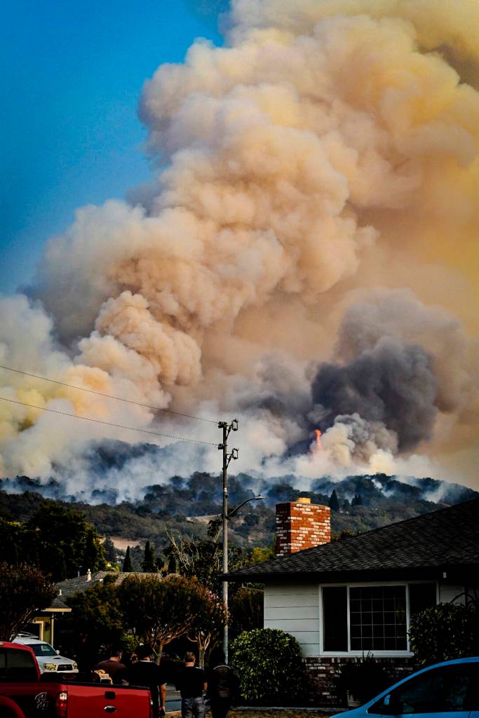 In this Oct. 11 photo, smoke rises from fires in Santa Rosa, California. (Derek Anderson via AP)