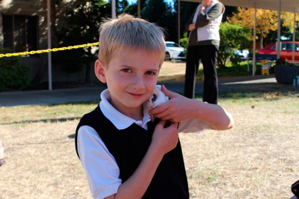 St. Thomas More student David Pehanich takes part in a Blessing of the Pets. (Contributed photo)