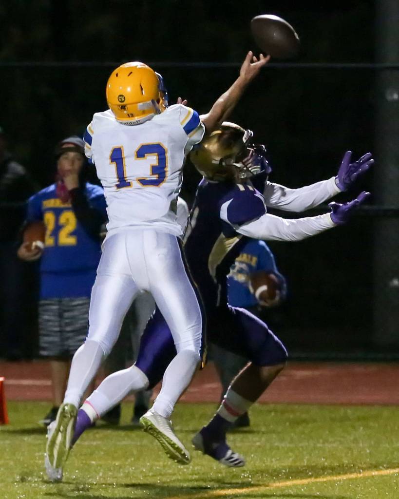 Ferndales James Hinson deflects a reception attempt from Oak Harbors Kyle Nickols during a game Oct. 13, 2017, at Oak Harbor High School. (Kevin Clark / The Herald)