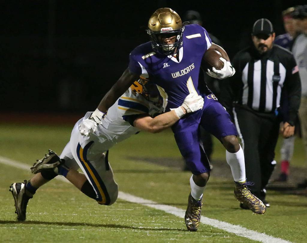 Ferndales Alex Cleary tackles Oak Harbors Taeson Hardin during a game Oct. 13, 2017, at Oak Harbor High School. (Kevin Clark / The Herald)