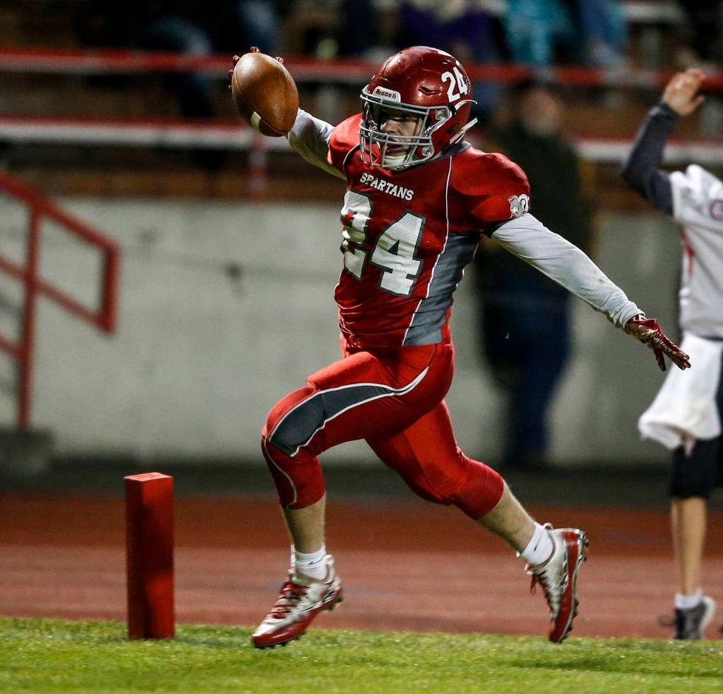 Stanwoods Nick Deline runs into the endzone for a touchdown in the second quarter of the annual Stilly Cup game against Arlington at Stanwood High School on Oct. 13, 2017. (Ian Terry / The Herald)