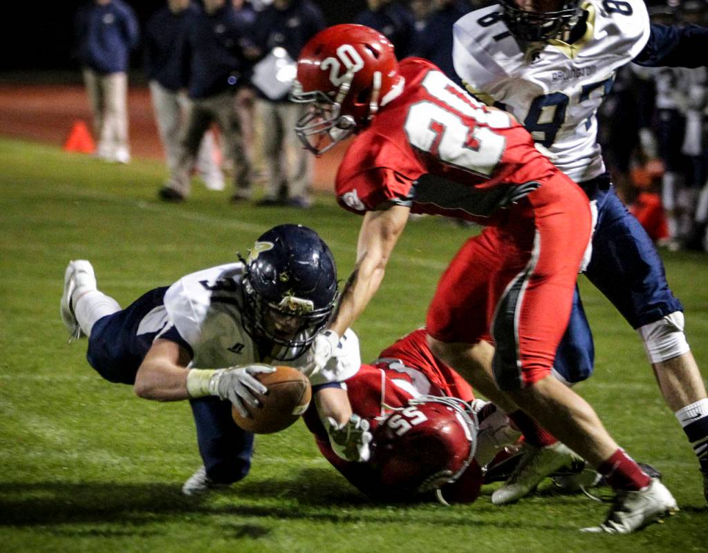 Arlingtons Payton Bastien (left) dives forward as Stanwoods Kaiser Hezel defends during the annual Stilly Cup game at Stanwood High School on Oct. 13, 2017. (Ian Terry / The Herald)