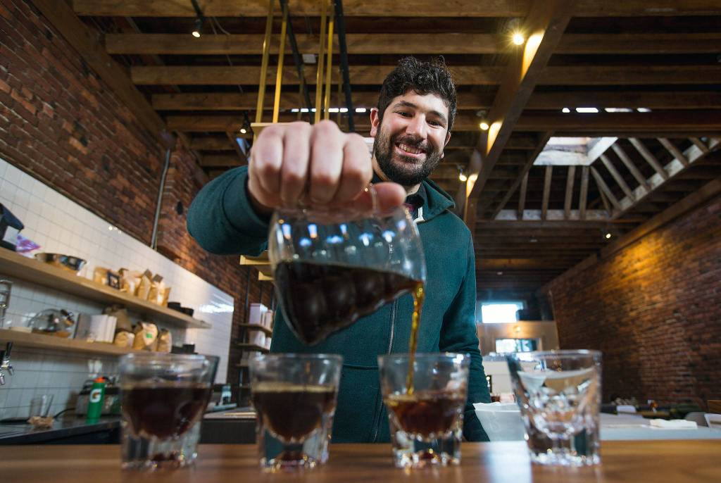 Barista Ryan Bisson brews up four coffees from Bean Box and reviews each while at Narrative Coffee on Oct. 3 in Everett. (Andy Bronson / The Herald)