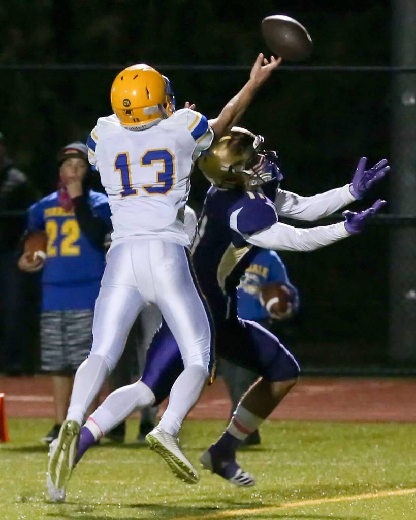 Ferndales James Hinson deflects a reception attempt from Oak Harbors Kyle Nickols at Oak Harbor High School on Oct. 13. (Kevin Clark / The Herald)