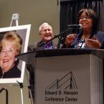 Sylvia Anderson, CEO of the Everett Gospel Mission (right), speaks to a large crowd Wednesday in Everett where she is awarded the Bethany of the Northwest Foundations Raili M. Hanson Inspirational Award. The late Raili Hanson (photo left) was the wife of former Herald publisher Larry Hanson (center), who is presenting the award. (Dan Bates / The Herald)
