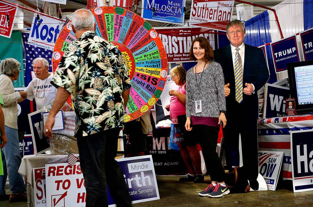 Herald columnist Julie Muhlstein meets up with a lifesize cardboard Donald Trump at the Evergreen State Fair on Aug. 29, 2016, in Monroe, before he became president. (Dan Bates / Herald file)