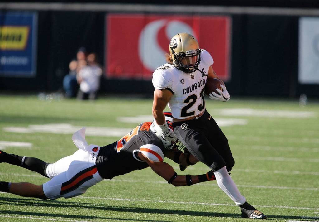 Colorado running back Phillip Lindsay (23) runs the ball during a game against Oregon State in Corvallis, Oregon on Saturday. (AP Photo/Timothy J. Gonzalez)