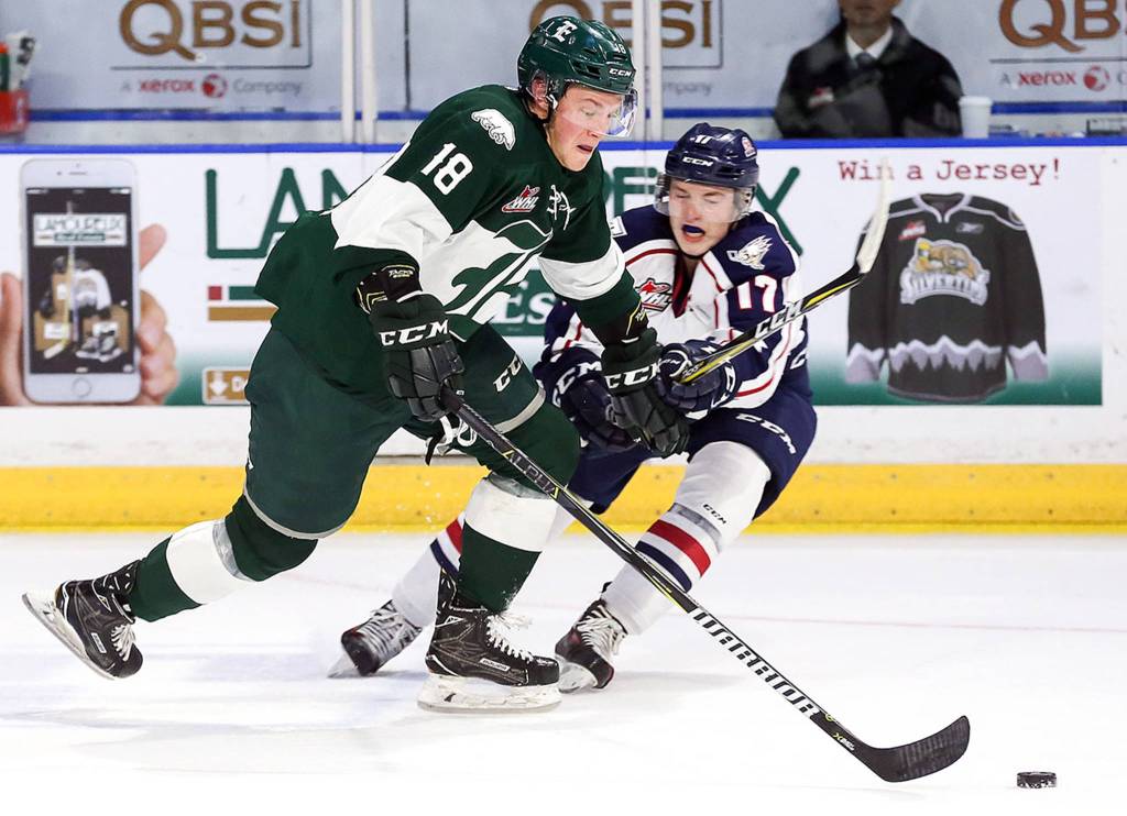 Everetts Brandson Hein (left) and Tri-Citys Carson Focht vie for control of the puck at Xfinity Arena in Everett on Oct. 18. (Kevin Clark / The Herald)