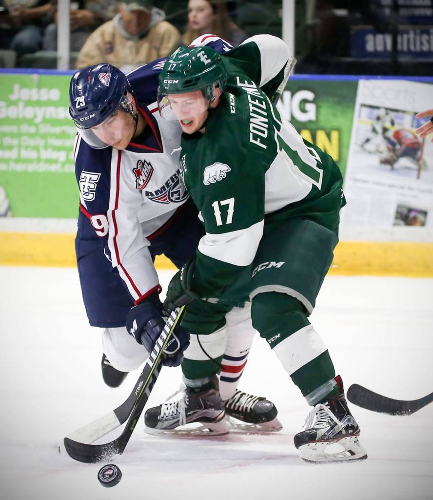 Tri-Citys Brett Leason (left) and Everetts Matt Fonteyne finish a face at Xfinity Arena in Everett on Oct. 18. (Kevin Clark / The Herald)