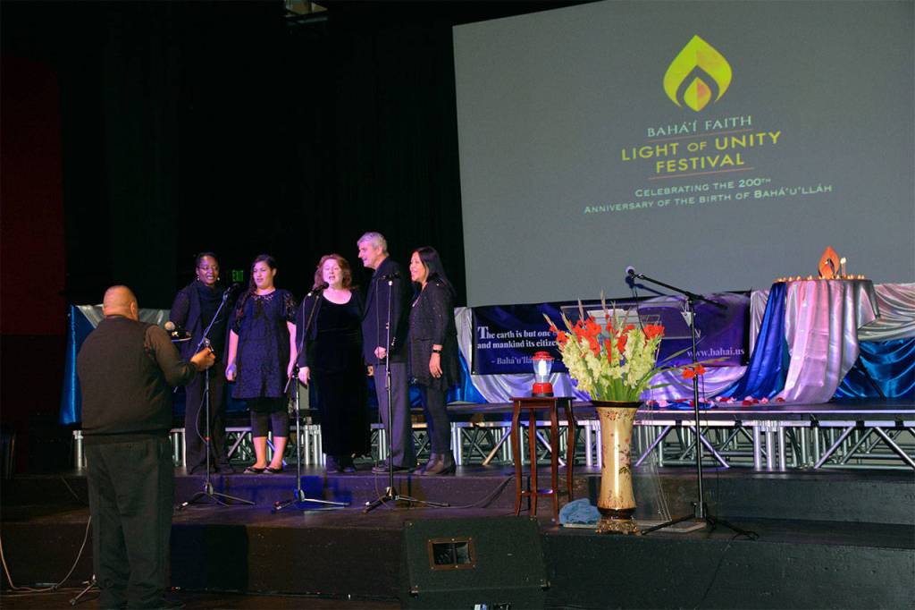 Bennett Montgomery, conductor, leads Misha Carter (from left), Naomi Montgomery, Elaine Montgomery, Chris Hansen and Daisy Hansen in music at the Light of Unity Festival, held Oct. 21 at Northwest Music Hall to mark the 200th anniversary of the birth of the founder of the Bahai faith. (Contributed photo)