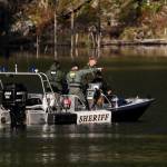 Investigators make their way across King Lake near the site of a helicopter crash Tuesday. (Ian Terry / The Herald)