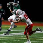 Edmonds-Woodways Niko Cooper (left) makes a leaping catch as Snohomishs Josh Dehaan defends during the Warriors Wesco 3A South-clinching 38-17 victory over the Panthers on Friday night at Edmonds Stadium. (Ian Terry / The Herald)