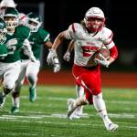 Snohomishs Keegan Stich (right) breaks free on his way to a long touchdown run, but the Panthers lost to Edmonds-Woodway 38-17 on Friday night at Edmonds Stadium. (Ian Terry / The Herald)