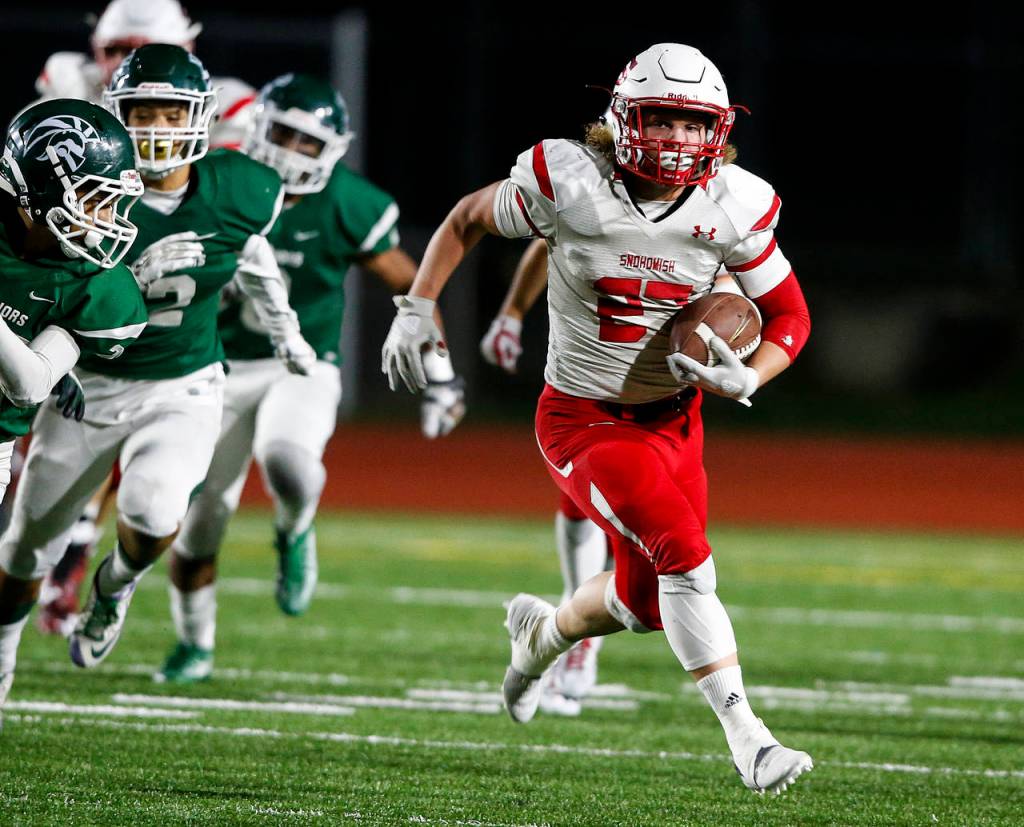 Snohomishs Keegan Stich (right) breaks free on his way to a long touchdown run, but the Panthers lost to Edmonds-Woodway 38-17 on Friday night at Edmonds Stadium. (Ian Terry / The Herald)