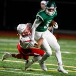 Edmonds-Woodways Aaron Richardson (right) breaks a tackle during the Warriors 38-17 win over Snohomish on Friday at Edmonds Stadium. (Ian Terry / The Herald)