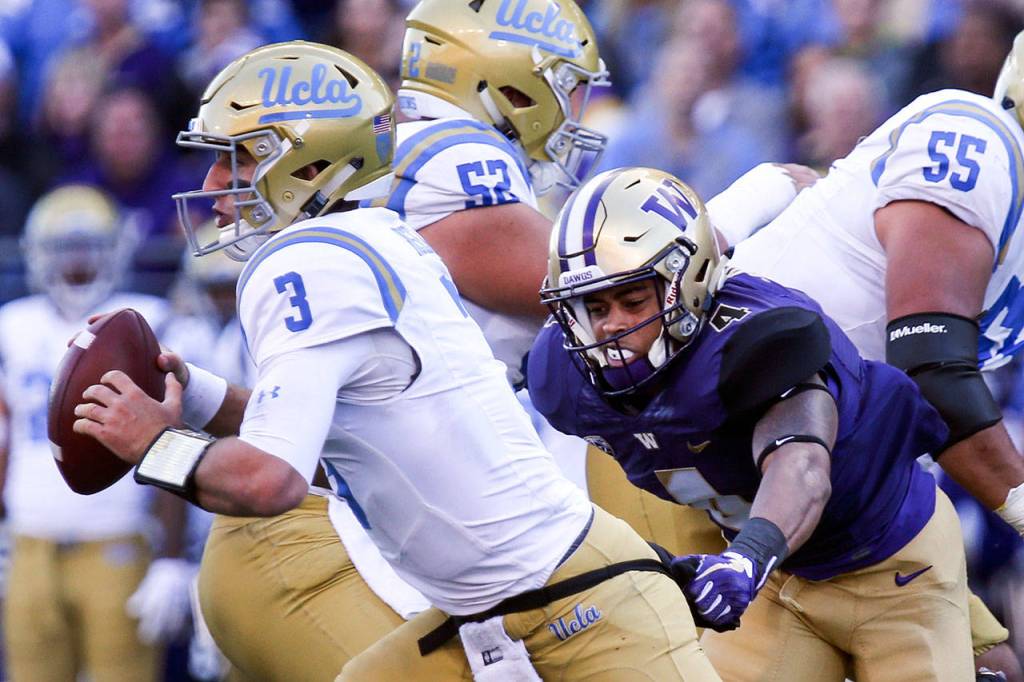 UCLAs Josh Rosen (left) is sacked by Marysville Pilchuck alum Austin Joyner on Oct. 28, 2017, at Husky Stadium. Washington won 44-23. (Kevin Clark / The Herald)