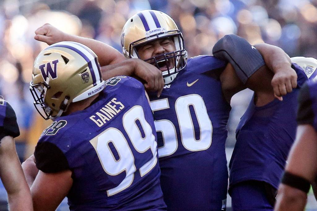 Washingtons Vita Vea (center) celebrates a sack with teammates on Oct. 28, 2017, at Husky Stadium. Washington won 44-23. (Kevin Clark / The Herald)