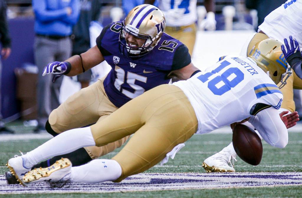 Washingtons DJ Beavers (15) forces a fumble by UCLAs Devon Modster on Oct. 28, 2017, at Husky Stadium. Washington won 44-23. (Kevin Clark / The Herald)